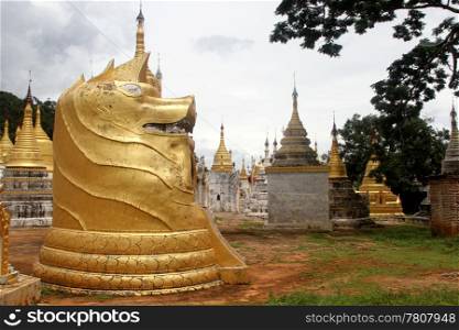 Statue of big Dog and stupas in Pindaya, Myanmar