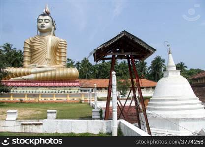 Statue of Buddha and dagoba in Wewurukannala Vihara, Sri Lanka