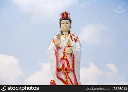 Statue of Guan Yin. Hotels in Dallas Krishna standing. Behind the sky bright.