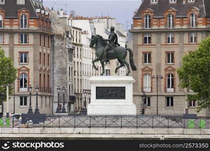 Statue of Henri IV in front of buildings, Paris, France