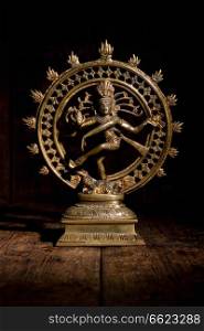 Statue of indian hindu god Shiva Nataraja - Lord of Dance on wooden background. Statue of Shiva Nataraja - Lord of Dance