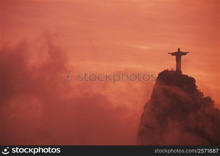 Statue of Jesus Christ on a hill at sunset, Christ the Redeemer Statue, Rio De Janeiro, Brazil