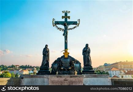 Statue of Jesus on Charles bridge in Prague at sunrise. Statue of Jesus in Prague