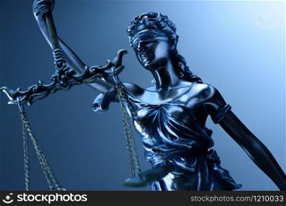 Statue of justice on blue background