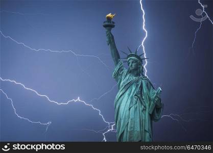 Statue of Liberty Neoclassical sculpture on Liberty Island southwest of Manhattan Island, USA. Powerful lightning strike.. Statue of Liberty
