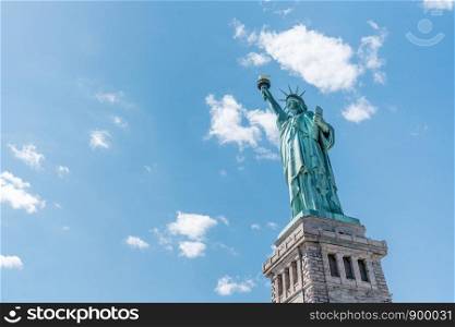 Statue of Liberty on sunny day, clear blue sky background. United States nation symbol, travel destination or America tourist attraction concept