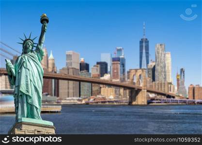 Statue of Liberty with background of Brooklyn bridge and Lower Manhattan skyscrapers bulding for New York City in New York State NY , USA