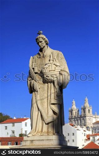 Statue of Saint Vicente de Fora in Lisbon and house roofs, Portugal&#xA;