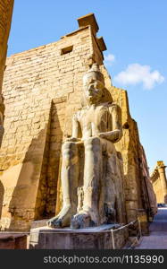 Statue of sitting pharaoh in Karnak Temple, Luxor. Statue of sitting pharaoh