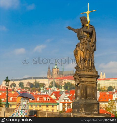 Statue of St. John the Baptist, the sculpture of Charles Bridge in Prague, Czech Republic, at morning.