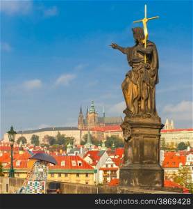 Statue of St. John the Baptist, the sculpture of Charles Bridge in Prague, Czech Republic, at morning.