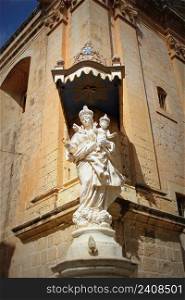 Statue of Virgin Mary with Jesus child on the corner of Carmelite Priory in Mdina. Malta .. Statue of Virgin Mary with Jesus child on the corner of Carmelite Priory in Mdina. Malta