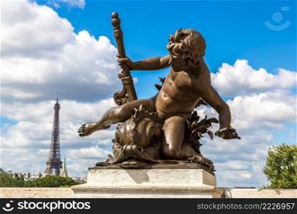 Statue on  the Pont Alexandre III with eiffel tower in background in a beautiful summer day in Paris, France