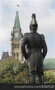 Statue with Parliament Building in the background, Parliament Hill, Ottawa, Ontario, Canada