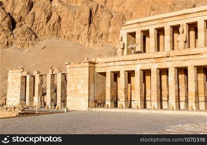 Statues and columns of Hatshepsut Temple in the rocks of Luxor. Colonnade in Hatshepsut Temple