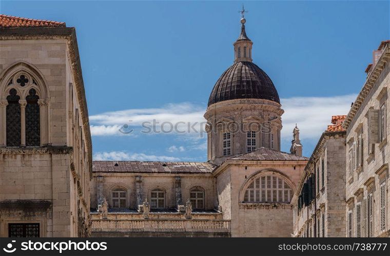 Statues and dome on cathedral church in the old town of Dubrovnik in Croatia. Details of roof of cathedral church in Dubrovnik old town