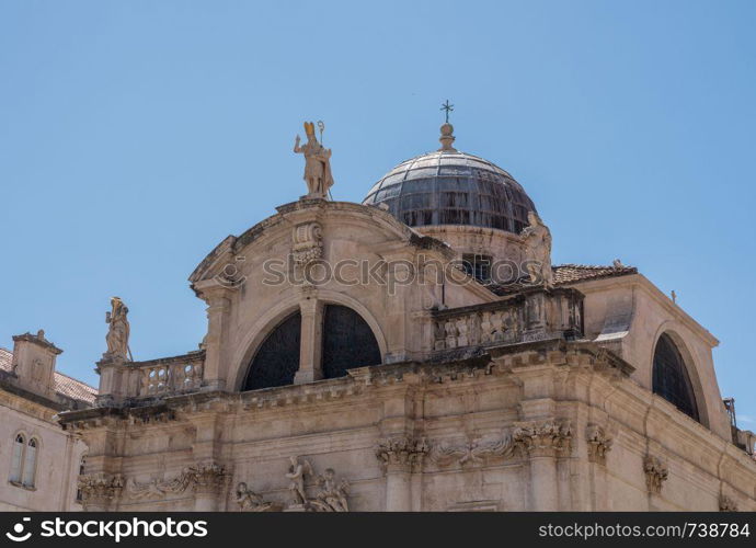 Statues and dome on St Blaise church in the old town of Dubrovnik in Croatia. Details of roof of St Blaise church in Dubrovnik old town