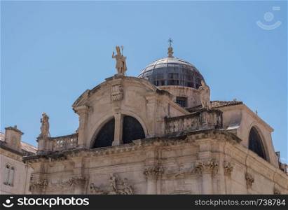 Statues and dome on St Blaise church in the old town of Dubrovnik in Croatia. Details of roof of St Blaise church in Dubrovnik old town
