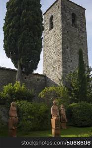 Statues in front of church bell tower, Gaiole in Chianti, Tuscany, Italy