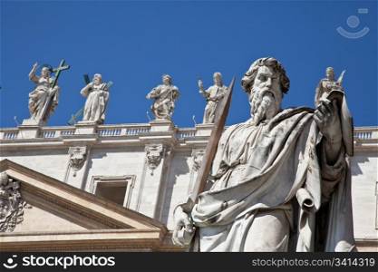 Statues in St. Peter Square (Rome, Italy) with blue sky background