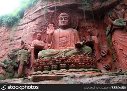 Statues near the wall of rock in EmeiShan, China