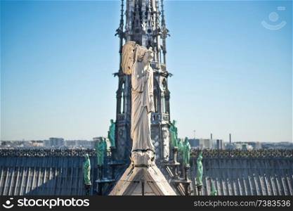 Statues of angel, chimeras and other creatures at roof of Notre-Dame de Paris. Paris, Fance