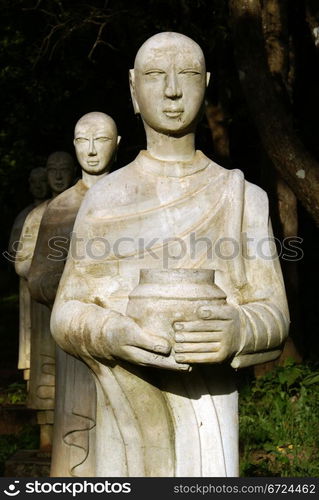 Statues of buddhist monks in the forest, Hsipo, Myanmar