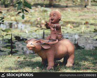 Statues of children playing in the garden in thailand.