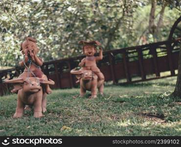 Statues of children playing in the garden in thailand.