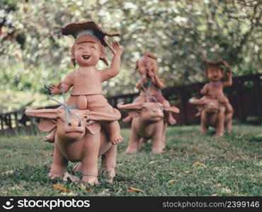 Statues of children playing in the garden in thailand.