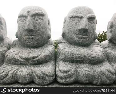 Statues of monks on the island of Jeju South Korea