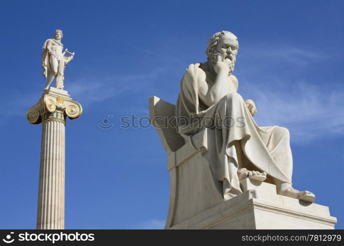 Statues of Socrates and Apollo in Athens, Greece. Neoclassical statues of Socrates (Greek ancient philosopher) and Apollo (god of the sun, medicine and the arts) in front of the Academy of Athens, Greece.