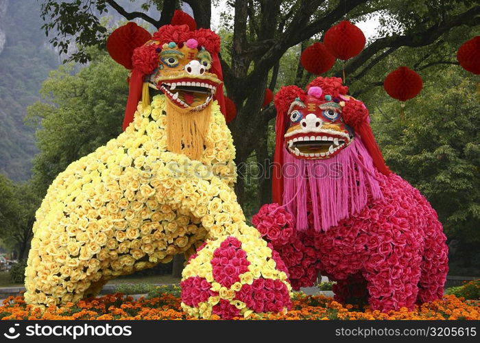 Statues of two dragons covered with flowers, Yungang Buddhist Caves, China