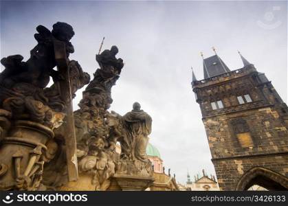 Statues on Charles Bridge and Bridge Tower in Prague.