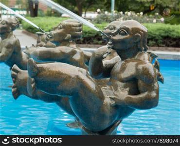 Statues spraying water at a fountain in a park located in Parkchester neighbourhood of Bronk, New York