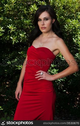 Statuesque brunette in red amongst the green