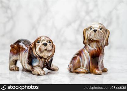 Statuettes of cute dogs  on white marble background