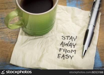 Stay away from easy advice or reminder - handwriting on a napkin with a cup of coffee