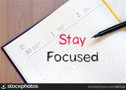 Stay focused text concept write on notebook