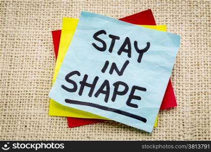 stay in shape reminder on a green sticky note against burlap canvas