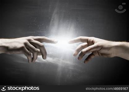Stay in touch. Close up of human hands reaching each other with fingers