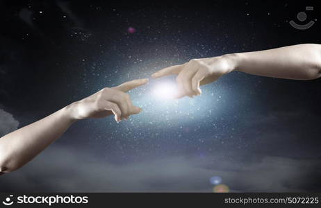 Stay in touch. Close up of human hands reaching each other with fingers