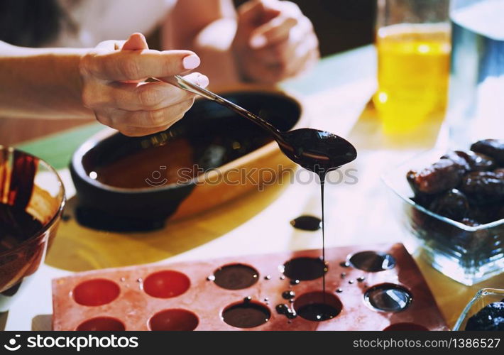 Staying at home woman preparing handmade vegetarian chocolate truffles