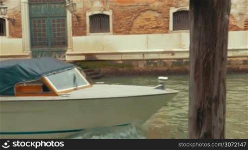 Steadicam shot of two touristic boats sailing in oppositie directions on canal of Venice. Traveling by water to go sightseeing in old city