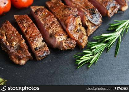 steak and vegetables on black plate