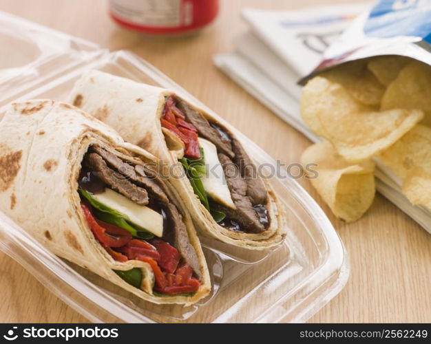 Steak, Cheese, Red Pepper And Barbeque Sauce Tortilla Wrap With A Can Of Cola And Packet Of Crisps