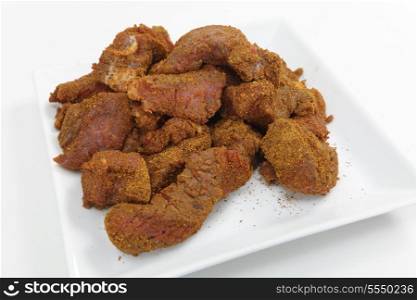 Steak coated with ras al hanout spices, at the start of preparation of a Moroccan beef tagine