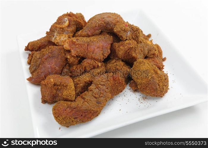 Steak coated with ras al hanout spices, at the start of preparation of a Moroccan beef tagine