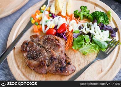 Steak homemade with french fries and fresh vegetable salad on wooden tray, healthy steak menu, Steak pork