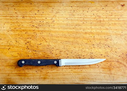 Steak knife on timber with copy space